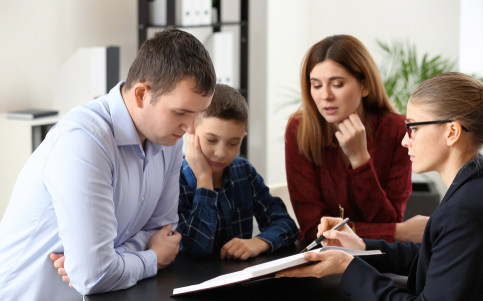 lawyer discussing documents with parents and child